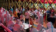 Residents line up for nucleic acid testing at a night market following a new case of the coronavirus disease (COVID-19) in Haikou, Hainan province, China August 3, 2021. China Daily via REUTERS/File Photo

