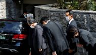 Japanese lawmaker Sanae Takaichi prays to the vehicle believed to be carrying the body of former Japanese Prime Minister Shinzo Abe, who was shot while campaigning for a parliamentary election, at his residence in Tokyo, Japan July 9, 2022. REUTERS/ Kim Kyung-Hoon