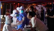 A man gets tested for the coronavirus disease (COVID-19) at a nucleic acid testing site, following the coronavirus disease (COVID-19) outbreak, in Shanghai, China July 12, 2022. REUTERS/Aly Song