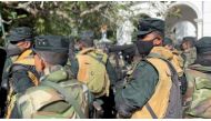 Members of the security force stand guard as people protest at Sri Lanka's Prime Minister Ranil Wickremesinghe's office, amid the country's economic crisis, in Colombo, Sri Lanka July 13, 2022 in this still image obtained from a social media video. Marlon Ariyasinghe/via REUTERS