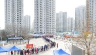 People line up in the Chinese city of Tianjin for nucleic acid testing for the coronavirus disease (COVID-19) in January after local cases of the Omicron variant were detected. Picture taken January 9, 2022. cnsphoto via REUTERS