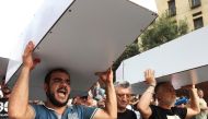 Demonstrators carry mockup coffins during a protest as Lebanon marks the two-year anniversary of the August 2020 Beirut port explosion, in Beirut, Lebanon August 4, 2022. (REUTERS/Mohamed Azakir)