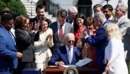 US President Joe Biden signs the CHIPS and Science Act of 2022 alongside Vice President Kamala Harris, House of Representatives Speaker Nancy Pelosi and Joshua Aviv, founder and CEO of SparkCharge, on the South Lawn of the White House in Washington on August 9, 2022. (REUTERS/Evelyn Hockstein)