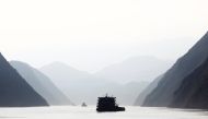 Ships sail on the Yangtze River near Badong, 100km (62 miles) from the Three Gorges dam in Hubei province August 7, 2012. REUTERS/Carlos Barria/File Photo