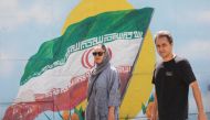 Iranians walk in a street, in Tehran, Iran, August 16, 2022. (Majid Asgaripour/West Asia News Agency via Reuters)