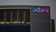 FILE PHOTO: The logo of the Adani Group is seen on the facade of one of its buildings on the outskirts of Ahmedabad, India, April 13, 2021. REUTERS/Amit Dave