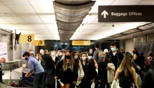 File Photo: Travelers wearing protective face masks to prevent the spread of the coronavirus disease reclaim their luggage at the airport in Denver, Colorado, US, November 24, 2020. (REUTERS/Kevin Mohatt)