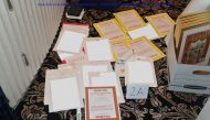 A redacted FBI photograph of documents and classified cover sheets recovered from a container stored in former US president Donald Trump's Florida estate, and which was included in a US Department of Justice filing and released on August 30, 2022. US Department of Justice/Handout via REUTERS 