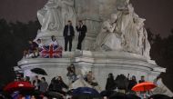 Crowds stand near Queen Victoria memorial as they gather around Buckingham Palace after Queen Elizabeth died aged 96, in London, on September 8, 2022. REUTERS/Toby Melville