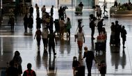 Travellers arrive at the Hong Kong International Airport on the first day the COVID hotel quarantine has been scrapped, in Hong Kong, China September 26, 2022. REUTERS/Tyrone Siu
