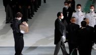 Akie Abe, wife of former Japanese Prime Minister Shinzo Abe, carries her husband's urn, as she leaves his state funeral at Nippon Budokan, in Tokyo, Japan, September 27, 2022. Eugene Hoshiko/Pool via Reuters 