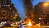 A police motorcycle burns during a protest over the death of Mahsa Amini, a woman who died after being arrested by the Islamic republic's 