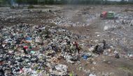 Waste recyclers look through heaps of waste unloaded from a garbage truck at a landfill for cardboard, plastic and metal, which they sell while working 12-hour shifts, as Argentina faces one of the world's highest inflation rates, set to top 100% this year, in Lujan, on the outskirts of Buenos Aires, Argentina October 5, 2022. REUTERS/Miguel Lo Bianco