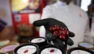 French chocolatier Damien Vidal poses with chocolates flavoured with Carolina Reaper chilli pepper at the Paris Chocolate fair in Paris, France, October 28, 2022. Reuters/Lucien Libert