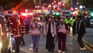 Rescue team and firefighters work at the scene where dozens of people were injured in a stampede during a Halloween festival in Seoul, South Korea, on October 30, 2022. REUTERS/Kim Hong-ji 