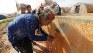 File Photo: An internally displaced Syrian girl drinks water at Teh camp in northern Idlib, Syria, on May 5, 2021. (REUTERS/Khalil Ashawi)

