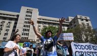 Supporters of Argentina's Vice-President Cristina Fernandez de Kirchner shout slogans outside the Courthouse Comodoro Py in Buenos Aires on December 6, 2022.   (Photo by Luis ROBAYO / AFP)