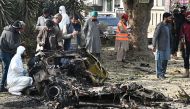 Police officers collect evidence at the site of a suicide car bombing in Islamabad, Pakistan, December 23, 2022. (REUTERS/Waseem Khan)

