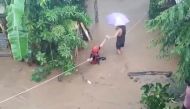 A rescuer helps people affected by floods in Gingoog city, Philippines December 25, 2022 in this screen grab obtained from a social media video. Philippine Red Cross/TWITTER@PHILREDCROSS/via REUTERS