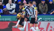 Newcastle United's striker Joelinton (left) celebrates with Bruno Guimaraes (centre) and Sven Botman after scoring their third goal during the English Premier League match against Leicester City at King Power Stadium in Leicester, central England on December 26, 2022. (Photo by Lindsey Parnaby / AFP) 