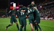 Liverpool's Spanish defender Stefan Bajcetic celebrates with teammates after scoring his team third goal during the English Premier League football match between Aston Villa and Liverpool at Villa Park in Birmingham, central England on December 26, 2022. (Photo by Oli SCARFF / AFP)