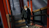A man wearing a face mask walks on the street during the coronavirus disease (COVID-19) pandemic in Hong Kong, China, December 28, 2022. REUTERS/Tyrone Siu