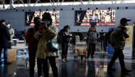 Travellers stand by their luggage at Beijing Capital International Airport, amid the coronavirus disease (COVID-19) outbreak in Beijing, China December 27, 2022. REUTERS/Tingshu Wang

