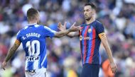 Espanyol's Spanish midfielder Sergi Darder (left) shakes hands with Barcelona's Spanish midfielder Sergio Busquets at the end of the Spanish League football match between FC Barcelona and RCD Espanyol at the Camp Nou stadium in Barcelona on December 31, 2022. (Photo by Pau BARRENA / AFP)