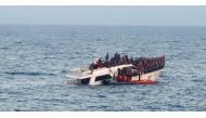 A handout photo provided by the Lebanese Army on December 31, 2022, shows a sinking migrant boat in Mediterranean waters, off the country's northern coast near Tripoli during a rescue operation by the Lebanese navy. (Photo by Lebanese Army Website / AFP) 
