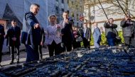 Croatia's Prime Minister Andrej Plenkovic (left) and European Commission President Ursula von der Leyen (centre) look at a miniature model of the capital city of Zagreb as they take a walk in Zagreb on January 1, 2023 during the visit of the EU Commission on the occasion of Croatia's entry to the passport-free Schengen zone. (Photo by DENIS LOVROVIC / AFP)