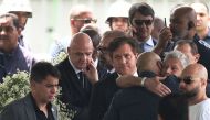 FIFA President Gianni Infantino (second left) and Conmebol President Alejandro Dominguez (third left) attends the wake of Brazilian football legend Pele at the Urbano Caldeira stadium in Santos, Sao Paulo, Brazil on January 2, 2023.  (Photo by CARL DE SOUZA / AFP)