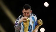 Argentina's Lionel Messi kisses the World Cup trophy after receiving the Golden Ball award as he celebrates after winning the World Cup at the Lusail Stadium in Qatar on December 18, 2022. (REUTERS/Kai Pfaffenbach)
