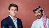 Norway's Magnus Carlsen with QCF President Mohammed Al Madhahka. 