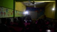Students attend a class at a private school during a nationwide power outage in Karachi on January 23, 2023. - A massive power breakdown in Pakistan on January 23 affected most of the country's more than 220 million people, including in the mega cities of Karachi and Lahore. (Photo by Asif HASSAN / AFP)