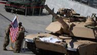 US soldiers stand with Polish and US flags near M1/A2 Abrams tank outside a hall of 30th International Defence Industry Exhibition in Kielce, Poland on September 5, 2022. File Photo / Reuters
