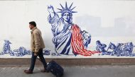 An Iranian man walks past an anti-U.S. mural on the wall of former U.S. Embassy in Tehran, Iran on January 25, 2023. Majid Asgaripour/WANA (West Asia News Agency)/Handout via REUTERS 