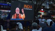People watch the BBC documentary 'India: The Modi Question', on a screen installed at the Marine Drive junction under the direction of the district Congress committee, in Kochi on January 24, 2023. (Photo by Arun Chandrabose / AFP)