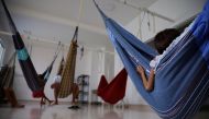 A Yanomami indigenous child, who is treated for malnutrition, sits in a hammock at a special yard for indigenous people of the Santo Antonio Children's Hospital, in Boa Vista, Roraima state, Brazil, January 27, 2023. (REUTERS/Amanda Perobelli)