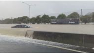 Stranded vehicles are seen during heavy rainfall in Auckland, New Zealand January 27, 2023, in this screen grab obtained from a social media video. @MonteChristoNZ/via Reuters