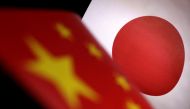 Printed Chinese and Japanese flags are seen in this illustration, July 21, 2022. REUTERS/Dado Ruvic/Illustration/File Photo
 