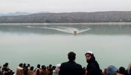 People gather as rescue workers search for the victims, after a boat carrying students capsized in Tanda lake in Kohat, Pakistan, January 29, 2023. (REUTERS)