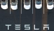 In this file photo taken on February 10, 2022, an aerial view shows cars parked at the Tesla Fremont Factory in Fremont, California. (Photo by JOSH EDELSON / AFP)