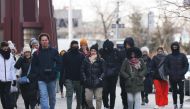 People bundle up as they shield themselves from cold winds as the area is seeing record-breaking low temperatures on February 03, 2023 in New York City. The Northeast US has seen a dramatic temperature drop as an Arctic front of cold air hits it. Michael M. Santiago/Getty Images/AFP 
