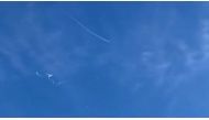 This still image taken from a cellphone video by Haley Walsh in Myrtle Beach, South Carolina, shows an alleged Chinese surveillance balloon after it was shot down (loser L) on February 4, 2023. (Photo by Jose Romero / AFP
