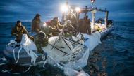 Sailors assigned to Explosive Ordnance Disposal Group 2 recover a high-altitude surveillance balloon off the coast of Myrtle Beach, South Carolina, on February 5, 2023.  (Photo by Petty Officer 1st Class Tyler Thompson / US NAVY / AFP)
