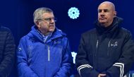 International Olympic Committee President (IOC) Thomas Bach (left) looks on during the award ceremony for the Women's Downhill event of the FIS Alpine Ski World Championship 2023 in Meribel, French Alps, on February 11, 2023. (Photo by Jeff PACHOUD / AFP)