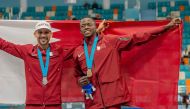 Mohammed Al Qarni and Musaab Adam celebrate after winning the silver and bronze medals respectively in the men's 1500m final.