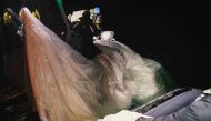 In this photo taken on February 5 2023, and obtained from the US Navy, sailors assigned to Explosive Ordnance Disposal Group 2 recover a high-altitude surveillance balloon off the coast of Myrtle Beach, South Carolina. Photo by Tyler Thompson / US NAVY / AFP