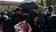 Syrian residents of Hatay city wait to cross the Turkish-Syrian border after they were affected by the 7.8-magnitude earthquake that struck the region nearly two weeks ago, at Cilvegozu border gate on February 17, 2023. (Photo by Yasin Akgul / AFP)