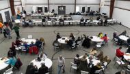 Residents receive $1000 checks and reimbursements for evacuation expenses from employees of Norfolk Southern on February 17, 2023 in New Waterford, Ohio. Michael Swensen/Getty Images/AFP
